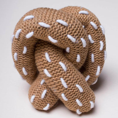 organic baby rattle pretzel toy. brown and white stitches as salt.